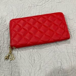 Red wallet, gold detailing on zipper & dangly.